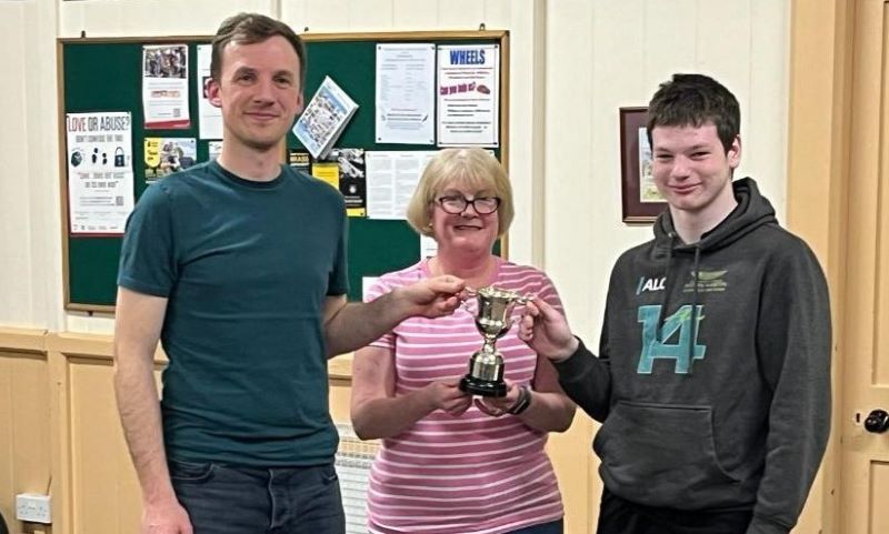 Alastair and Josh receive the trophy from Training Band leader Claire Whitworth